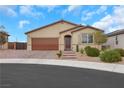 Inviting single-story home featuring a well-manicured lawn and neutral colored facade and a two car garage at 3018 Carothers Ct, North Las Vegas, NV 89032