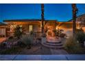 Inviting home exterior illuminated at dusk with a beautifully landscaped front yard and brick entrance at 3163 Elk Clover St, Las Vegas, NV 89135