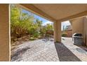 Private back patio with pavers, perfect for outdoor dining and relaxation, with lush landscaping at 3167 Biccari Ave, Henderson, NV 89044