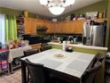 Inviting eat-in kitchen featuring oak cabinetry, stainless appliances, and a cozy dining area perfect for casual meals at 3673 Spring Day Ct, Las Vegas, NV 89147