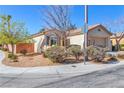 View of a charming single-story home with mature landscaping and a tile roof at 3685 Australian Cloud Dr, Las Vegas, NV 89135