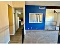 View of the home's carpeted living room, complete with stairs and access to the upstairs rooms at 3729 La Junta Dr, Las Vegas, NV 89120