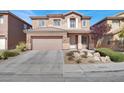 Inviting two-story home with landscaped front yard, desert landscaping, and a two car garage at 4036 W Bird Man Ln, North Las Vegas, NV 89084