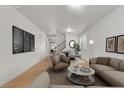 A bright living room with a staircase leading to a dining space at 4036 W Bird Man Ln, North Las Vegas, NV 89084