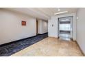 Hallway features marble floors, elevators and carpeting at 51 E Agate Ave # 506, Las Vegas, NV 89123