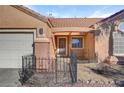 Single story home with a terra cotta roof, desert landscaping and an attached two car garage at 540 Viva Serenade Way, Henderson, NV 89015