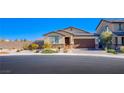 Charming one-story home features a two-car garage, stone accents, and desert-friendly landscaping at 5648 Vermillion Ridge St, North Las Vegas, NV 89031