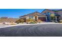 Inviting one-story home with stone details, two-car garage, and a low-maintenance desert front yard at 5648 Vermillion Ridge St, North Las Vegas, NV 89031