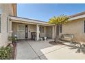 Inviting home entrance with a decorative security door, a charming bench, and a mature palm tree at 5775 W Desert Inn Rd, Las Vegas, NV 89146