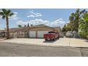 Single-story home with a two-car garage and a spacious driveway, with a red truck parked in front at 5775 W Desert Inn Rd, Las Vegas, NV 89146