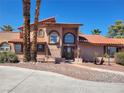 Attractive two-story home with a tile roof, decorative windows, and a well-manicured front yard at 5820 W Desert Inn Rd, Las Vegas, NV 89146