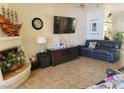 Comfortable living room with tile floors, neutral decor, and a cozy fireplace at 5820 W Desert Inn Rd, Las Vegas, NV 89146