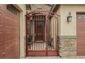 This property includes an ornate gate, stone accents, and a welcoming front door at 6217 Starflare St, Las Vegas, NV 89148
