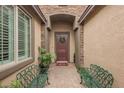 Covered entryway with decorative benches, wreath and stone accents at 6217 Starflare St, Las Vegas, NV 89148