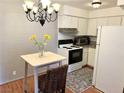 Compact kitchen featuring white cabinetry, granite countertops, and a stainless steel oven range at 625 S Royal Crest Cir # 2, Las Vegas, NV 89169