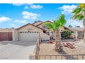 Inviting home featuring low-maintenance desert landscaping, a two-car garage, and a quaint front yard at 6611 Ellerhurst Dr, Las Vegas, NV 89103