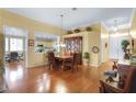 Dining room with hardwood floors and a view into the spacious kitchen at 7172 Painted Paradise St, Las Vegas, NV 89131