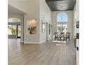 Bright dining room with tall ceilings, modern light fixture, and large windows providing ample natural light at 7904 Riviera Beach Dr, Las Vegas, NV 89128