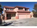 Charming two-story home with a three-car garage and balcony detail, showcasing a delightful exterior at 8122 Delphi Ct, Las Vegas, NV 89117