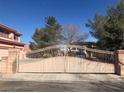 Wrought iron security gate and lush landscaping provide enhanced privacy at 8122 Delphi Ct, Las Vegas, NV 89117