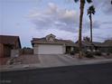 Inviting single-Gathering home featuring a spacious driveway and desert landscaping for low maintenance at 824 Holly Lake Way, Henderson, NV 89002