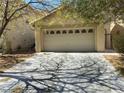 Attached two-car garage with a neutral color palette and well-maintained driveway at 8329 Brilliant Ruby Ct, Las Vegas, NV 89139
