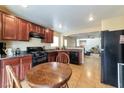 Charming kitchen with wood cabinetry, black appliances, and a cozy breakfast nook at 8329 Brilliant Ruby Ct, Las Vegas, NV 89139