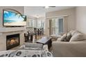 Cozy living room with fireplace, ceiling fan, and sliding door access to the outside at 9050 W Warm Springs Rd # 1093, Las Vegas, NV 89148