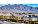 Rooftop solar panels highlight homes in a desert community with mountain views at 9380 Lunar Effect St, Las Vegas, NV 89143