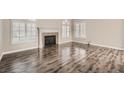 Beautiful living room with modern hardwood floors and a cozy fireplace at 10115 Tree Bark St, Las Vegas, NV 89183
