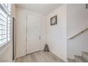 Inviting home entryway featuring tile floors, neutral walls, with simple decor, and a staircase at 10490 Palmadora St, Las Vegas, NV 89178