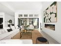 Open-concept living room with fireplace, high ceilings, and ample seating at 10921 Rossa Peak Ave, Las Vegas, NV 89135