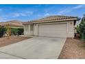 Attractive single-Gathering home displaying a two-car garage, desert landscaping, and a beautiful tiled roof at 1115 Pearl Marble Ave, North Las Vegas, NV 89081