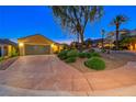 Charming home exterior showcasing a spacious driveway, well-manicured landscaping, and a two-car garage at 2 Cerchio Centrale, Henderson, NV 89011