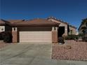 Single-story home with a two-car garage, complemented by desert landscaping for low maintenance at 2118 Chapman Ranch Dr, Henderson, NV 89012