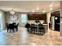 Open concept kitchen with stainless steel appliances, granite countertops and pendant lighting at 2204 Valdina St, Henderson, NV 89044