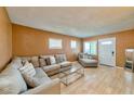 Cozy living room featuring wood flooring, sofa and large windows at 247 Tungsten St, Henderson, NV 89015