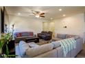 Cozy living room featuring plush seating, a ceiling fan, and ample space at 2804 Colts Ave, North Las Vegas, NV 89032