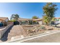 Attractive house with xeriscape landscaping, decorative rock, brick driveway and wrought iron gated entry at 3083 Paintedhills Ave, Las Vegas, NV 89120