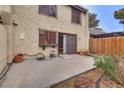 Private backyard with a concrete patio, block fence, and mature landscaping at 3301 China Dr, Las Vegas, NV 89121