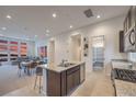 Modern open-concept kitchen with granite countertops, stainless steel appliances, and views of the living area at 3346 Esker Ridge Ave, Henderson, NV 89044
