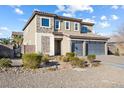 A well-maintained two-story home with stone accents, a three-car garage, and an inviting front yard at 3386 W Haleh Ave, Las Vegas, NV 89141