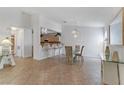 Dining area boasts chandelier and bar seating, connecting to a modern kitchen at 3660 Renovah St # 204, Las Vegas, NV 89129