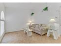 Cozy living room features modern glass table and neutral color palette at 3660 Renovah St # 204, Las Vegas, NV 89129