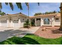 Inviting single-story home featuring a three-car garage and attractive desert landscaping at 3684 Miguels Ln, Las Vegas, NV 89120