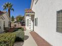 The exterior side of the home showcases meticulous landscaping and easy access to the front door at 3761 Tohono Canyon St, Las Vegas, NV 89147