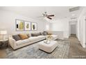 Bright loft space with a large sectional sofa, decorative pillows, neutral walls and a patterned rug at 3920 Beverly Elms St, Las Vegas, NV 89129