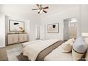 Bright main bedroom boasts neutral colors, a dresser, large windows and an ensuite bathroom at 3920 Beverly Elms St, Las Vegas, NV 89129