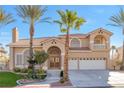 Inviting two-story home with arched entry, tile roof, and a well-manicured lawn at 4024 Mansion Hall Ct, Las Vegas, NV 89129
