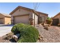 Single-story home featuring desert landscaping and a two-car garage at 4125 Gliding Gulls Ave, North Las Vegas, NV 89084